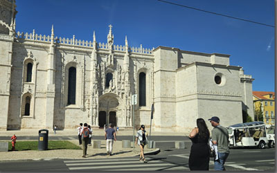 A group of people walking in front of a building