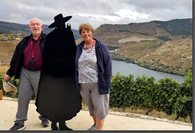 A person and person standing next to a silhouette of a shadow